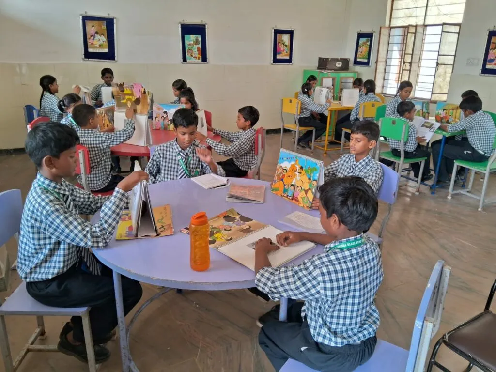 Children studying at round tables