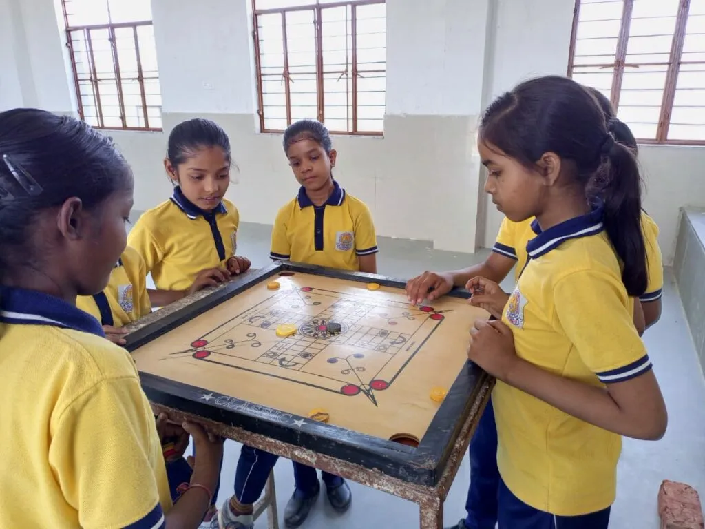 Girls playing carrom board game